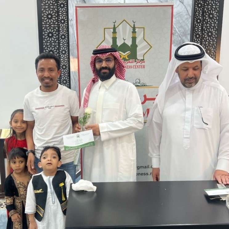 A family of New Muslims receives financial support in the form of Zakat at Islam Awareness Center.